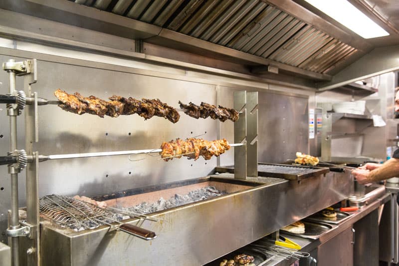 Meat roasting over charcoal in the Ela Kendro kitchen